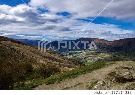 Lookout from Queenstown to Wannika overlooking a valley on a windy day in New Zealand 117114332