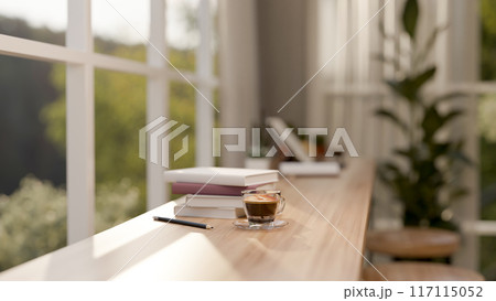 A long wooden table against the window in a contemporary minimalist cafe seating area. 117115052