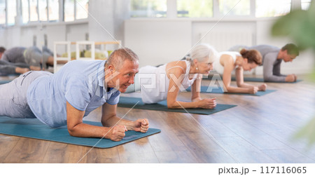 Elderly man doing pilates in group 117116065