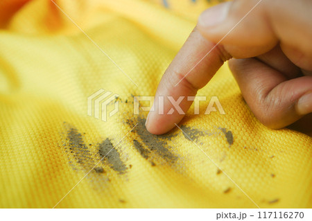 dirty mud stain on a yellow color shirt dirty mud stain on a yellow color shirt 117116270