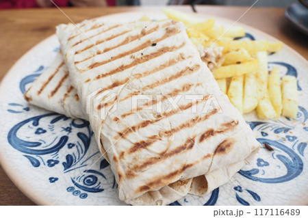 chicken warp and potato chips on a plate chicken warp and potato chips on a plate 117116489