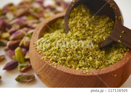 Wooden bowl filled with pistachios paste, a natural and nutritious superfood Wooden bowl filled with pistachios paste, a natural and nutritious superfood 117116505