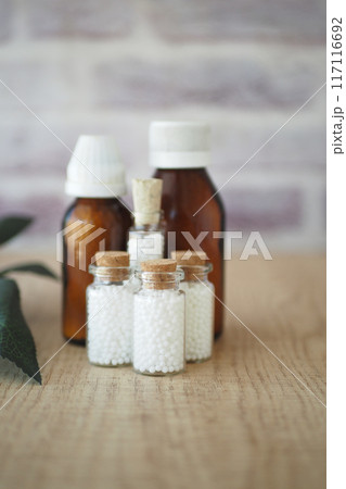 Homeopathic pills containers on a table  117116692
