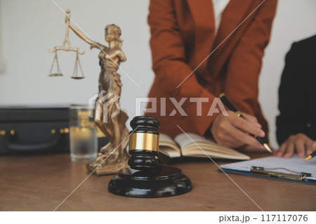 Lawyer, legal advisor, businessman brainstorming information on agreement details Business contracts in legal processing books for accuracy in contract documents. joint financial investment. 117117076