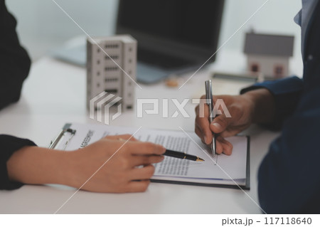 Sale representative offer house purchase contract to buy a house or apartment or discussing about loans and interest rates 117118640