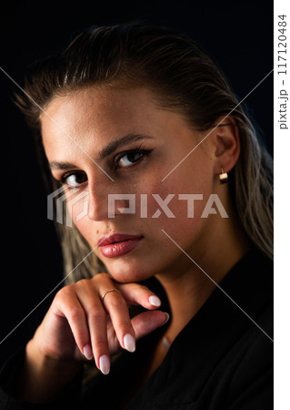 Close up of womans face with hand on chin, including different facial features Close up of womans face with hand on chin, including different facial features 117120484