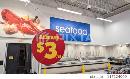 Close-up of always $3 per bound sign hanging on the roof Inside a Superstore in Coquitlam. Close-up of always $3 per bound sign hanging on the roof Inside a Superstore in Coquitlam. 117124009