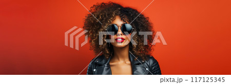 Portrait of a young woman wearing hightech equipment .glasses and headphones on red background 117125345
