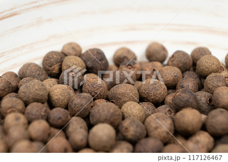 Macro photography of black peppercorns, hot spice 117126467