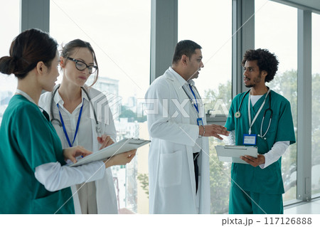 Doctors Examining Medical Cards Of Patients Doctors Examining Medical Cards Of Patients 117126888
