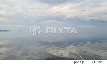 Smooth lake with reflective sky Smooth lake with reflective sky 117127848