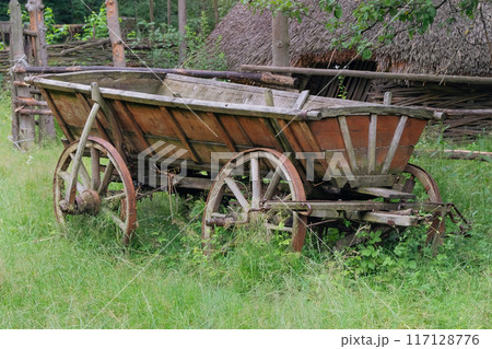 Wooden wheels. Retro wooden cart. Village vehicle in countryside. 117128776