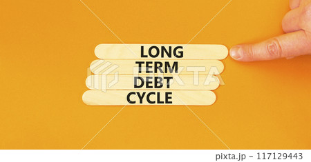 Long term debt cycle symbol. Concept words Long term debt cycle on wooden stick. Beautiful orange table orange background. Businessman hand. Business Long term debt cycle concept. Copy space. Long term debt cycle symbol. Concept words Long term debt cycle on wooden stick. Beautiful orange table orange background. Businessman hand. Business Long term debt cycle concept. Copy space. 117129443