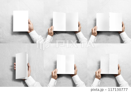 Hand holding blank white flyer brochure booklet in hand 117130777