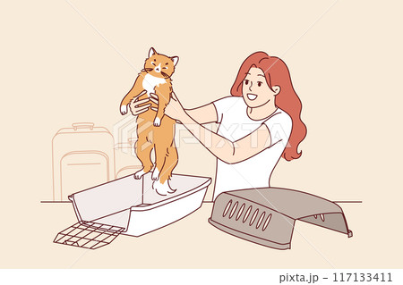 Animal cage for traveling with cat, near woman preparing pet for trip to airport 117133411