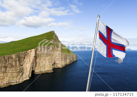 National Faroese flag waving against a background of Vagar island 117134715