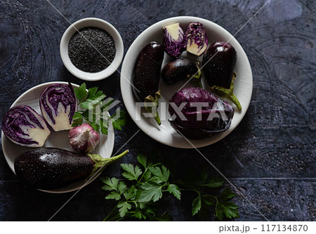Purple vegetables arranged on a dark table Purple vegetables arranged on a dark table 117134870
