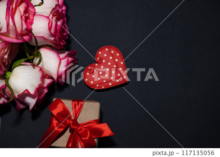 Vertical Valentines Day background with blank paper card mockup, gifts, red hearts, confetti on pink. Vertical Valentines Day background with blank paper card mockup, gifts, red hearts, confetti on pink. 117135056
