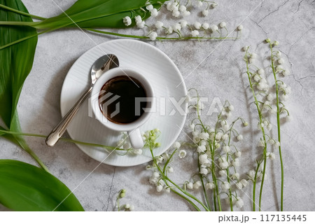 Lily of the valley flowers in glass vase, black background, selective focus Lily of the valley flowers in glass vase, black background, selective focus 117135445