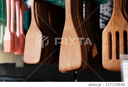 Various kitchen utensils made of wood in the stand. Copy the place for the close-up text. Environmental friendliness. Reuse. Handmade work. 117135640