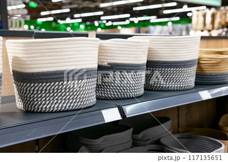 A wicker basket in the store made of ecological materials. Reuse of items. Handmade work. 117135651