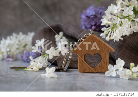 Real estate agent handing over house keys in hand 117135714