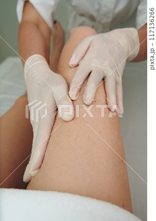 Professional Massage Therapy Session Focused on Relaxation and Pain Relief at a Spa 117136266