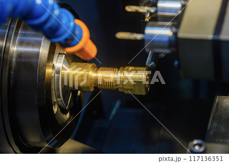 The  multi tasking CNC lathe machine swiss type milling the brass fitting parts. 117136351