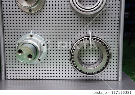 different bearings on a metal background. Part of mechanism. different bearings on a metal background. Part of mechanism. 117136381