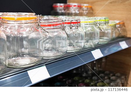 Neatly organized labeled food pantry in a home kitchen with spices grains flour rice sugar nuts 117136446