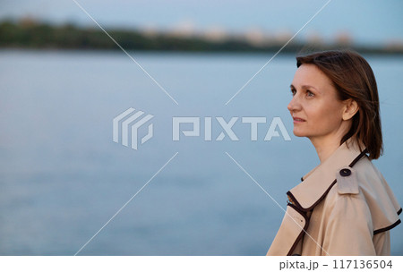 Young woman in formal clothes walking near grey wall outdoors, space for text Young woman in formal clothes walking near grey wall outdoors, space for text 117136504