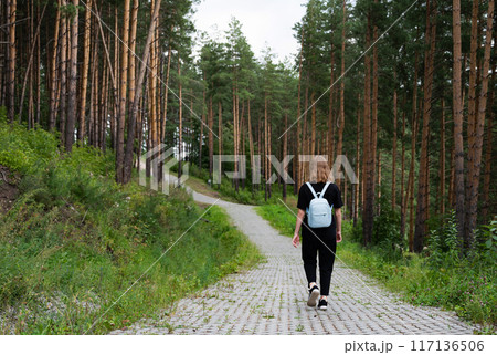 woman traveler with backpack and looking at amazing forest, wanderlust travel concept, space for text, atmospheric epic moment woman traveler with backpack and looking at amazing forest, wanderlust travel concept, space for text, atmospheric epic moment 117136506