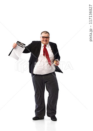 Full-length of fat man, employee in formal wear and glasses, walking with smile with documents isolated on white background. Successful meeting with colleagues 117136827