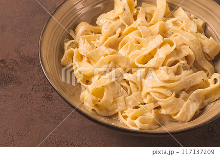 Fettuccine, tagliatelle, in creamy garlic sauce, Italian traditional cuisine, pasta carbonaro, Fettuccine, tagliatelle, in creamy garlic sauce, Italian traditional cuisine, pasta carbonaro, 117137209