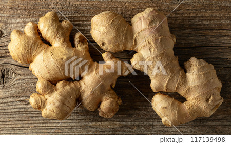 Ginger on a old wooden board. 117139498