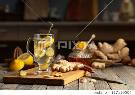 Ginger tea with lemon and honey on an old wooden table. 117139504