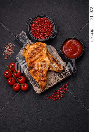 Delicious fresh grilled chicken fillet with spices and herbs Delicious fresh grilled chicken fillet with spices and herbs 117139726