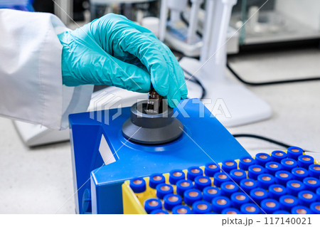 Samples are shaken by a chemist with a vortex mixer before HPLC analysis Samples are shaken by a chemist with a vortex mixer before HPLC analysis 117140021