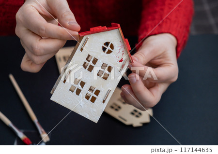 Sustainableminded Christmas cozy atmospheric festive decor in modern scandinavian home handmade decoration. Tutorial for making do it yourself craft wooden houses. Seasonal activity for kids 117144635