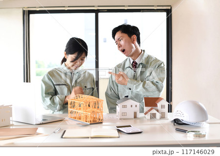 建設模型の前で口論をする男女の作業員 117146029