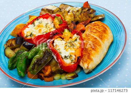 Top view of tasty baked vegetables, stuffed peppers and chicken fillet 117146273