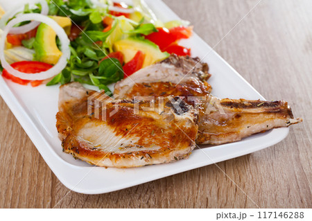 Pork escalope with salad from avocado, tomatoes and corn salad Pork escalope with salad from avocado, tomatoes and corn salad 117146288