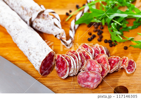 Traditional spanish thin salami sausage Fuet, sliced Traditional spanish thin salami sausage Fuet, sliced 117146305