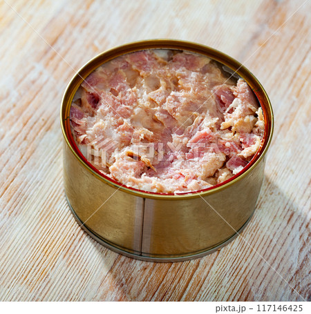 Tin can with ham on a wooden surface 117146425