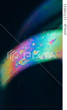 Oil rainbow. Blur ink mix. Defocused blue orange pink color acrylic dye blend curve wave flow on dark black abstract art background. 117148012