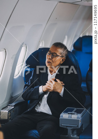 headache in the airplane, man passenger afraid and feeling bad during the flight in plane 117149695