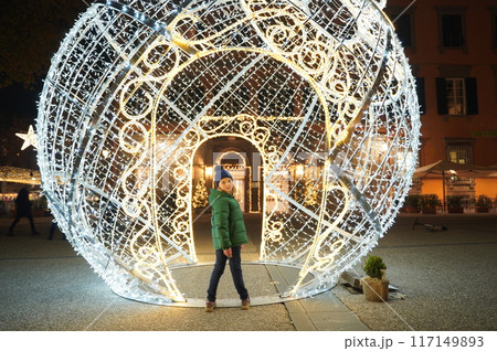 Schoolgirl with beautiful Christmas light decoration of city 117149893
