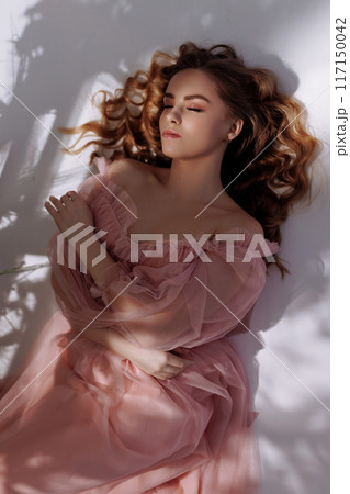 A beautiful woman in a pink dress. 117150042