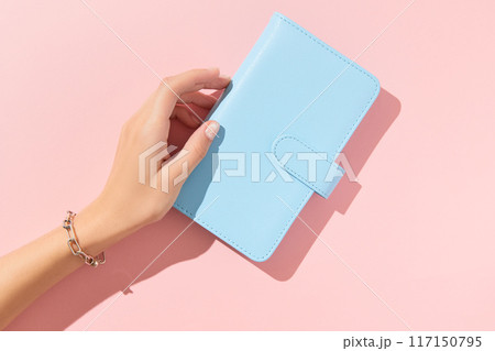 Womans hand with trendy nude manicure on pink background. Summer nail design Womans hand with trendy nude manicure on pink background. Summer nail design 117150795