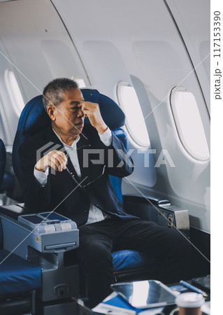 headache in the airplane, man passenger afraid and feeling bad during the flight in plane headache in the airplane, man passenger afraid and feeling bad during the flight in plane 117153390